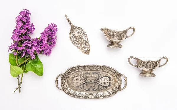 Vintgae silver dishes and lilac flowers. — Stock Photo, Image