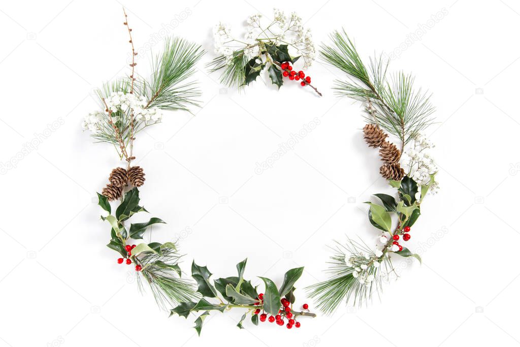 Christmas floral flat lay. Frame with ilex leaves and red berries