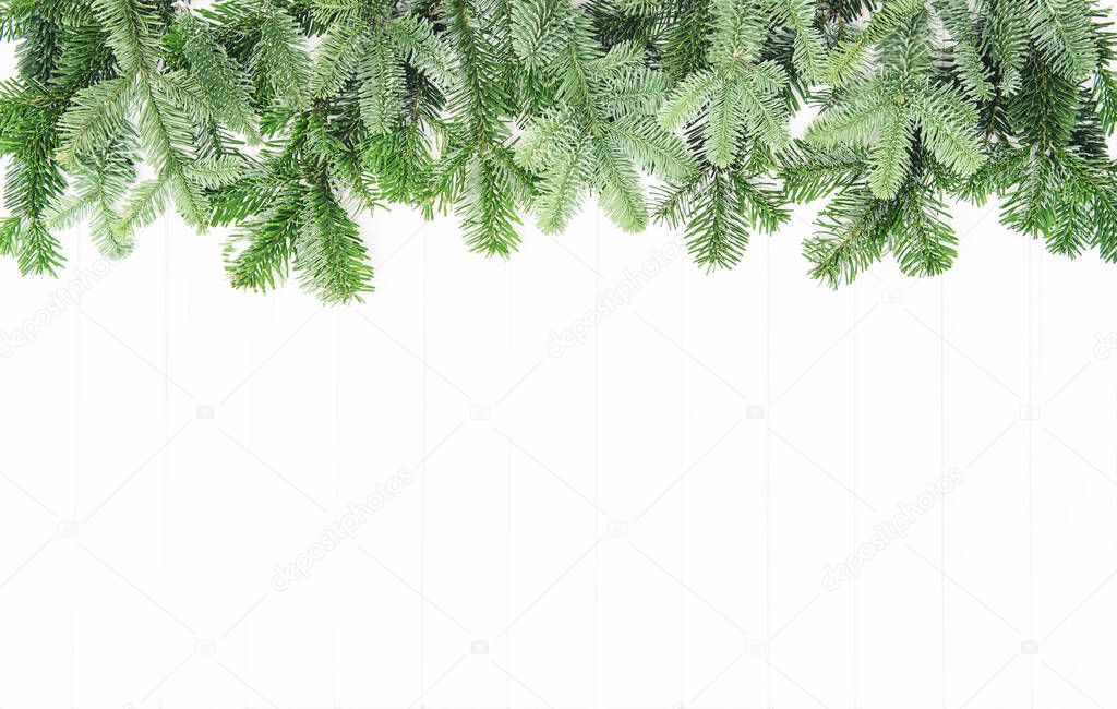 Spruce branches on bright wooden background. Christmas template