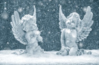 little guardian angels in snow. christmas decoration clipart