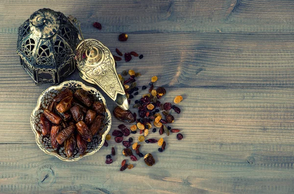 Still life with vintage orintal latern, raisins and dates — Stock Photo, Image