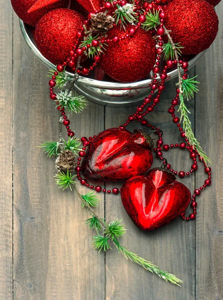 Vintage christmas background with red baubles and hearts — Stock Photo, Image