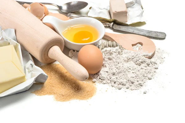 Bakning ingredienser ägg, mjöl, socker, smör, jäst — Stockfoto