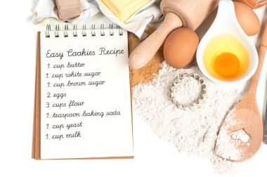 recipe book and baking ingredients eggs, flour, sugar, butter, y clipart