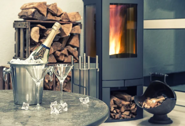 Festive home interior wirh champagne, two glasses and fireplace — Stock Photo, Image