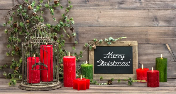 Vintage christmas decoration red candles and pine branch — Stock Photo, Image