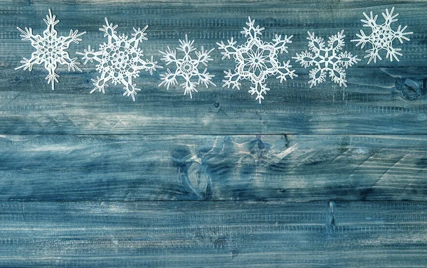 Snowflakes border over rustic wooden background. winter holidays — Stock Photo, Image