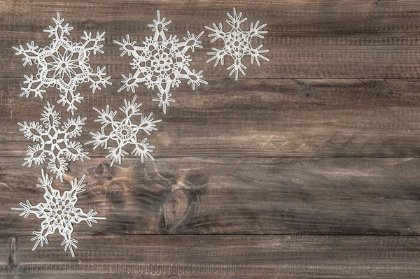 Snowflakes over rustic wooden background — Stock Photo, Image