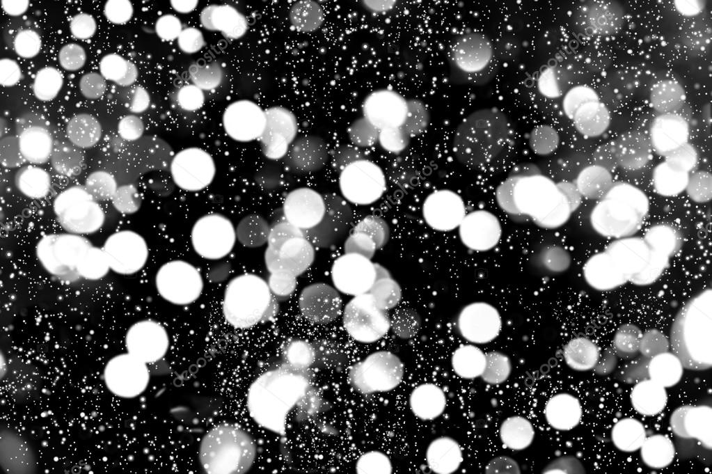 defocused lights with snowfall effect. winter night. abstract ba