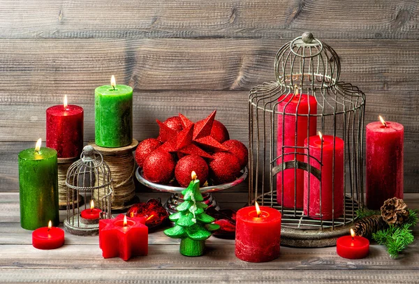 Christmas still life with burning candles and red baubles — Stock Photo, Image