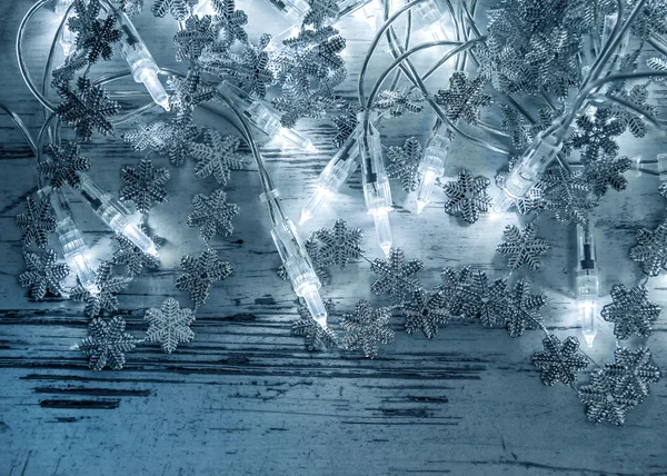 Christmas lights decoration with silver snowflakes — Stock Photo, Image