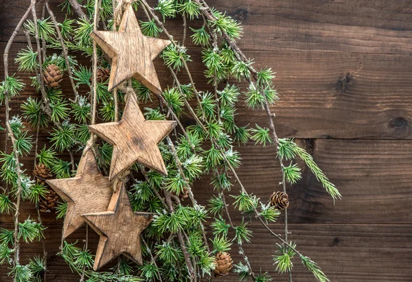 Christmas decorations wooden stars and pine tree branches — Stock Photo, Image