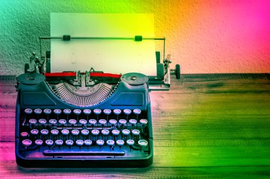 Vintage typewriter with color spot lights. Creativity concept clipart