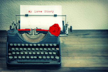 Vintage typewriter with white paper and red rose flower. Love St clipart
