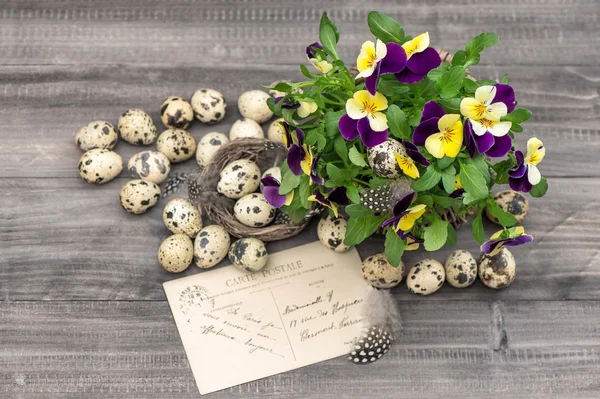 Fleurs, oeufs de caille et carte de voeux — Photo