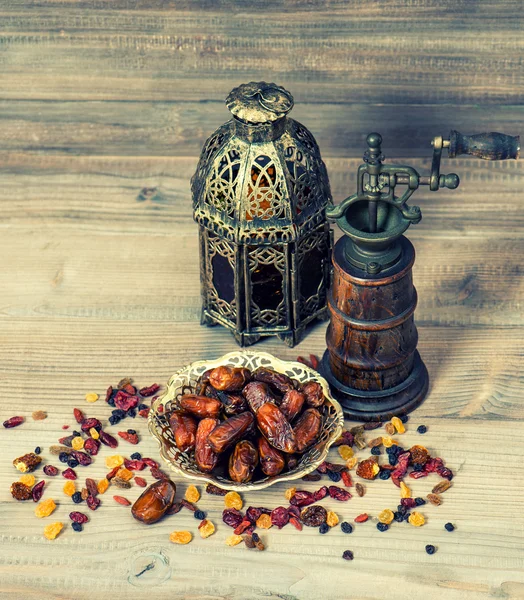 Still life with vintage oriental lantern and mill. Raisins and d — Stock Photo, Image