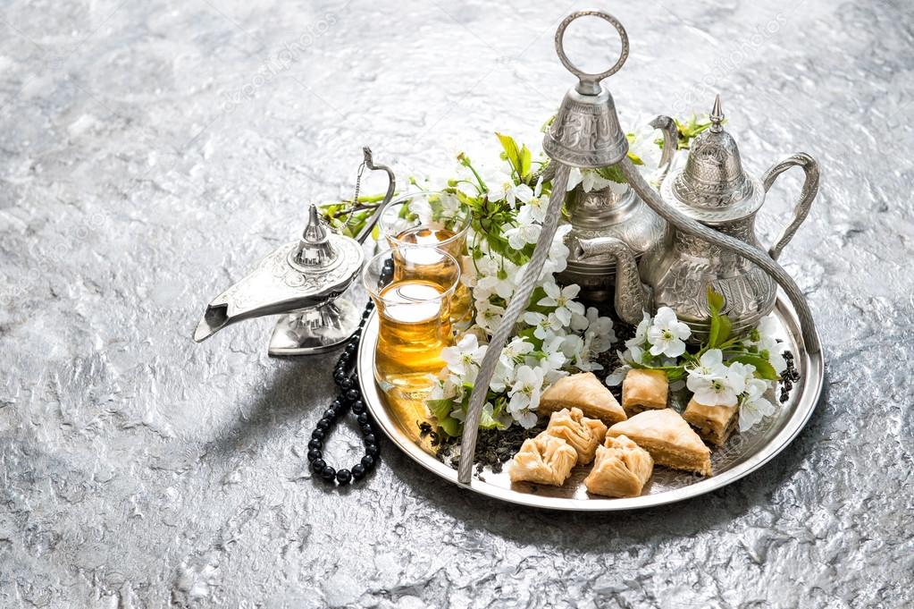 Tea pot and glasses, traditional oriental delight baklava. Islam