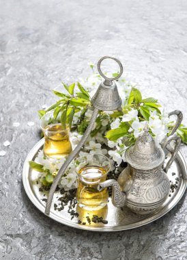 Tea glasses and pot. Oriental silver tableware. Flowers decorati clipart