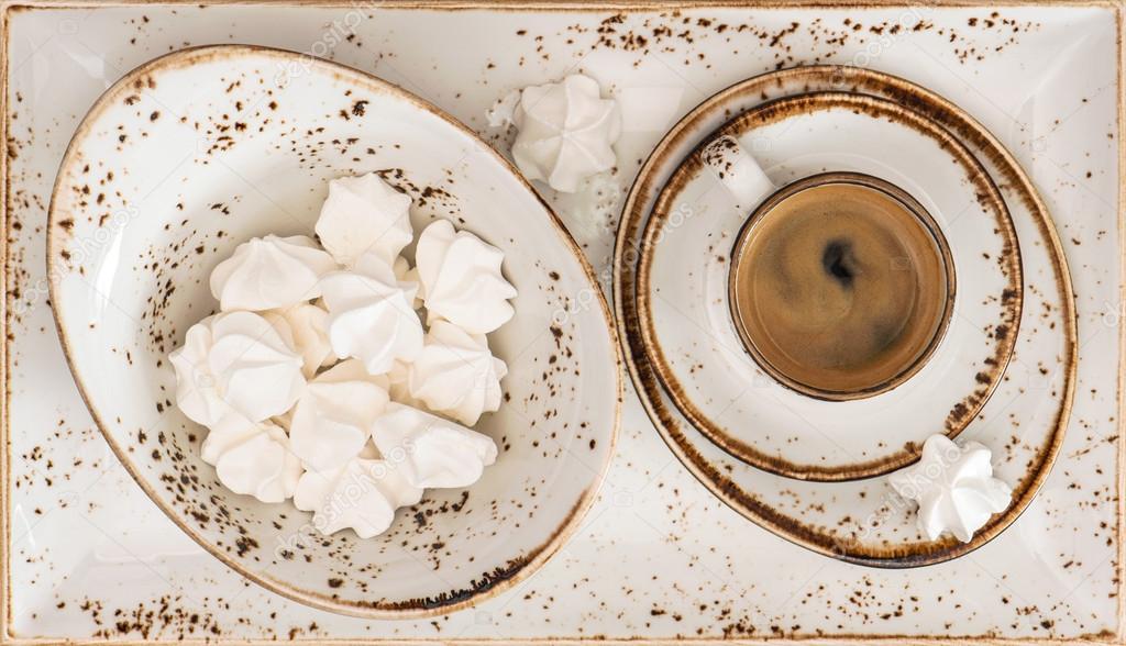 Black coffee with meringue cookies. Retro style porcelain tablew