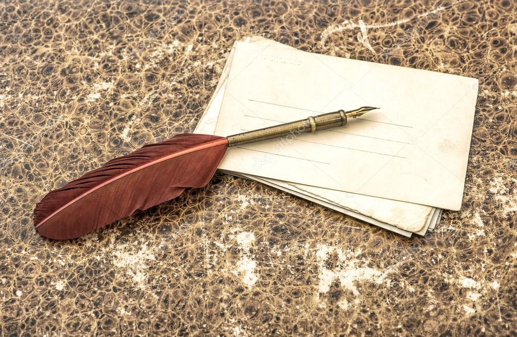 Antique feather pen and paper sheets. Retro style