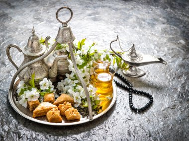 Tea glasses and pot, oriental traditional delight baklava. Vinta