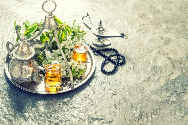 Tea table setting with arabian lantern and rosary. Islamic holid — стокове фото