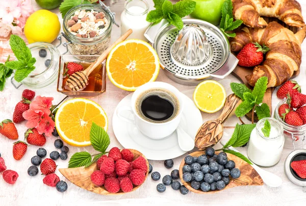 Breakfast with coffee, croissants, granola, honey, berries, frui — Stock Photo, Image