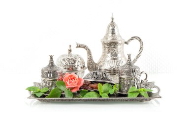 Holidays tea table setting with mint leaves and rose flower. Ori