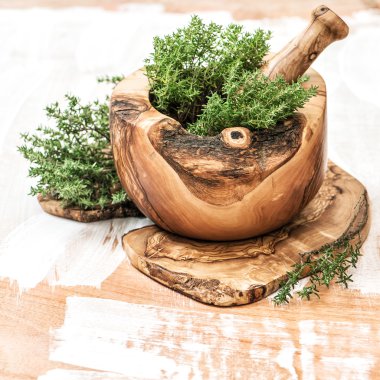 Mortar with fresh thyme herb. Healthy food ingredients clipart