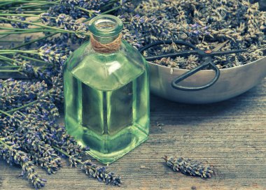 Lavender oil with fresh flowers and scissors. Vintage style
