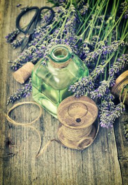 Lavender flowers bouquet with herbal oil and home tools. Retro s