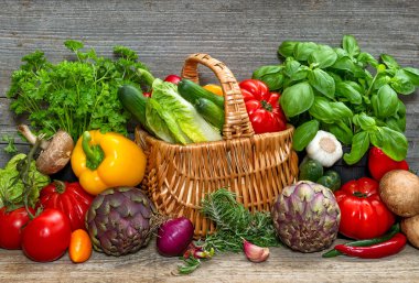 Vegetables and herbs on wooden background. Fresh food ingredient