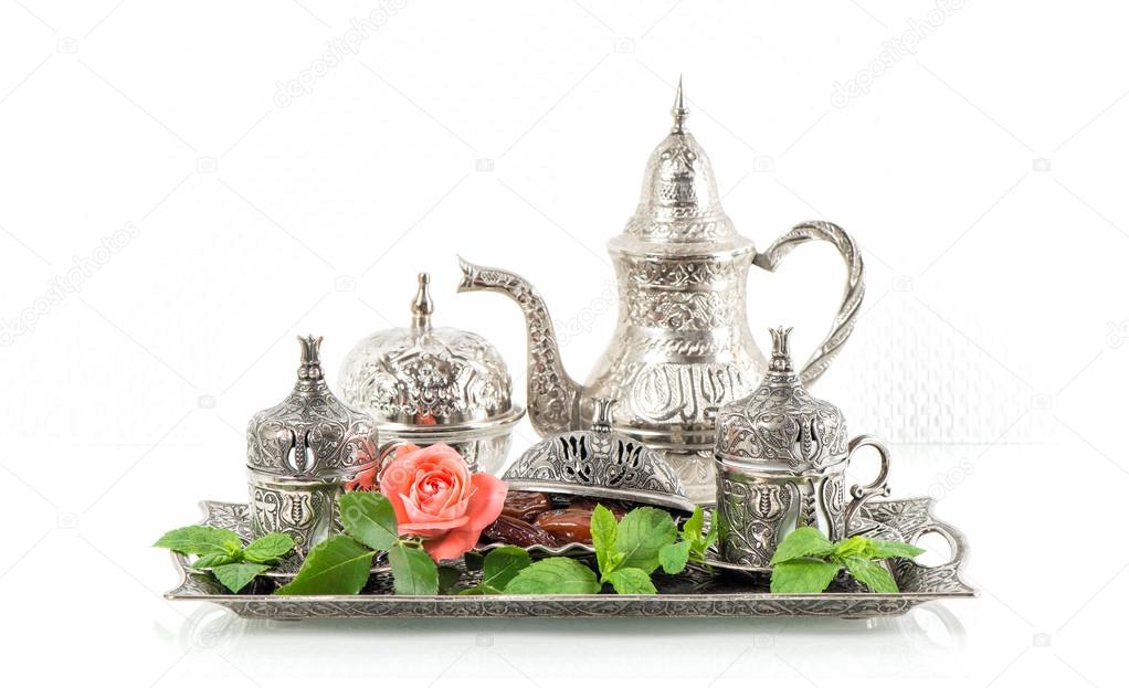 Holidays tea table setting with mint leaves and rose flower. Ori