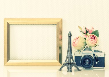 Golden picture frame, flowers and vintage camera. Nostalgic deco
