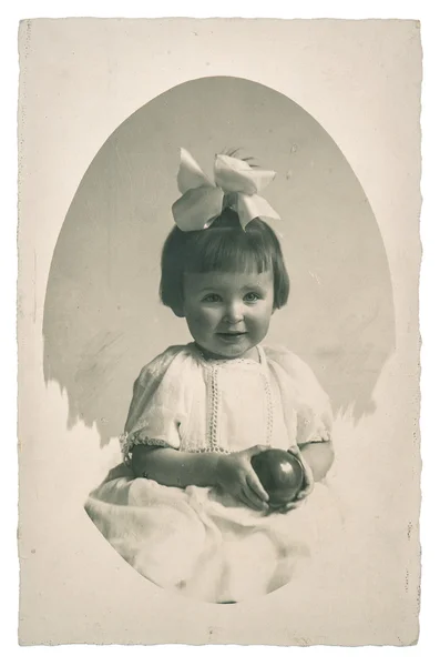 Old family photo portrait of little girl with toy ball — Stock fotografie