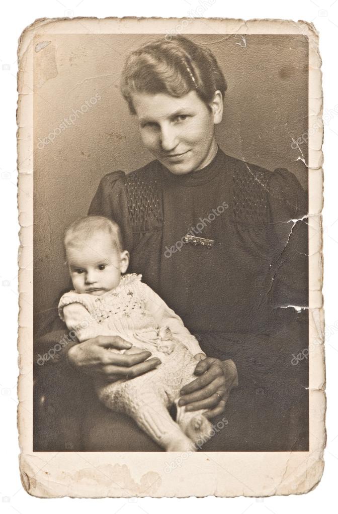 Vintage photo portrait of mother with baby wearing vintage cloth