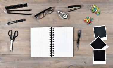 Open book, polaroid photo frames and writing tools office school