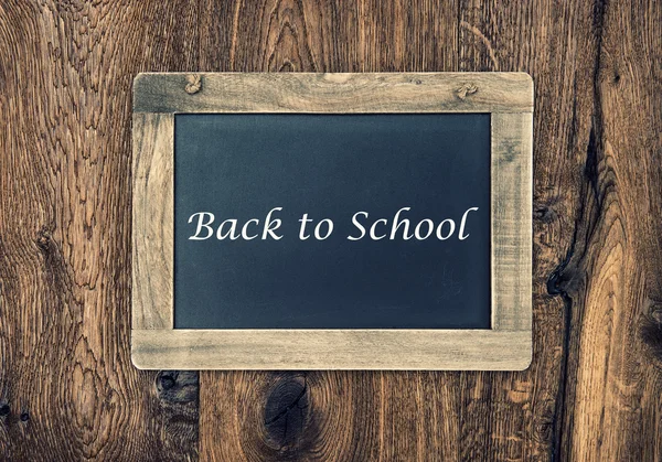 Vintage blackboard on wooden wall. Back to School — Stock Photo, Image