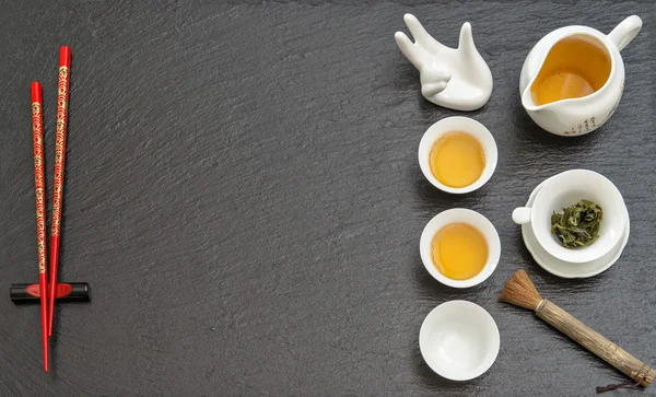 Tableware for traditional tea ceremony. Teapot, cups and red cho — Stock Photo, Image