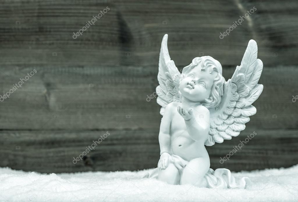 Little white angel in snow. Christmas decoration