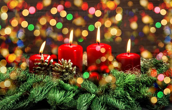 Advent decoration with burning candles and colorful lights — Stock Photo, Image