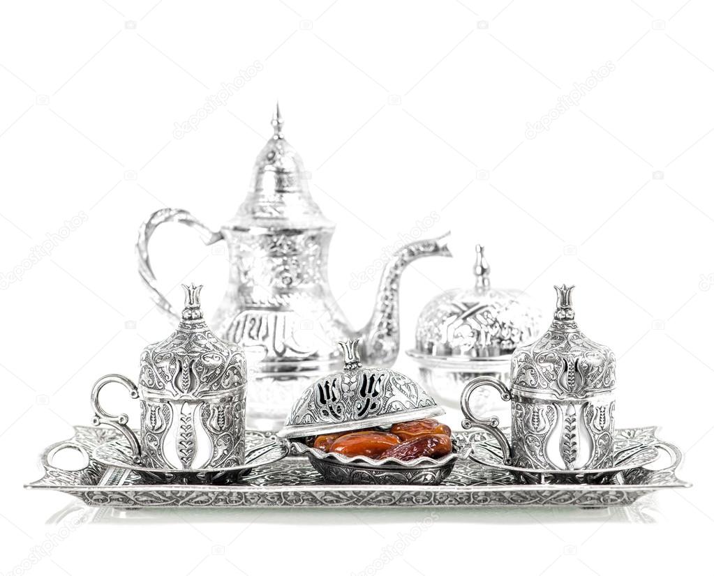 Table setting with silver tableware. Oriental hospitality