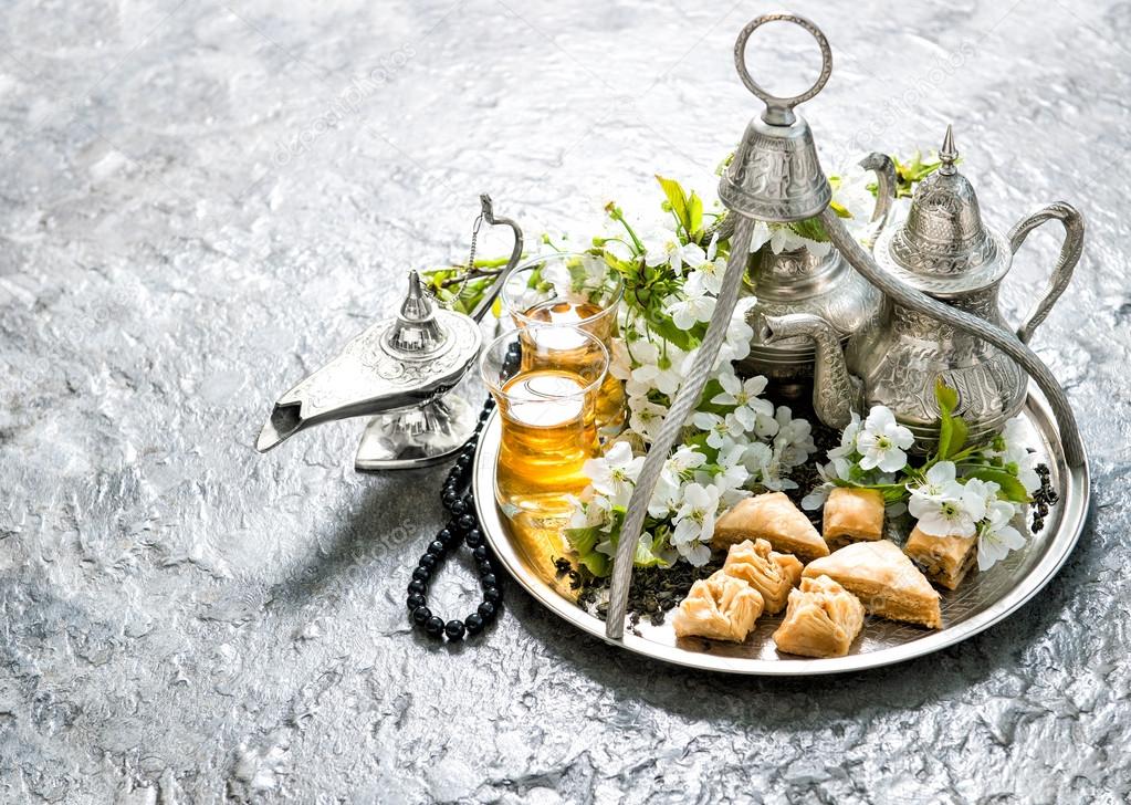 Tea pot and glasses, sweets. Islamic holidays. Hari Raya Aidilfi