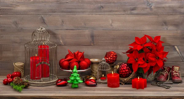 Christmas decoration with burning candles red flowers — Stock Photo, Image