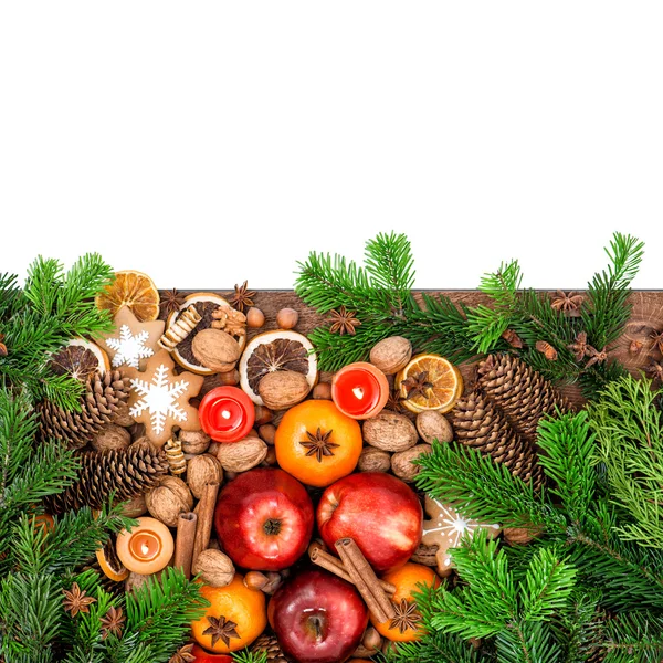 Apples, tangerine fruits, cookies and spices with christmas tree — ストック写真