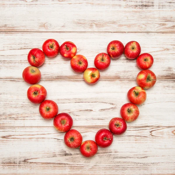 Red apples heart shape — Stock Photo, Image