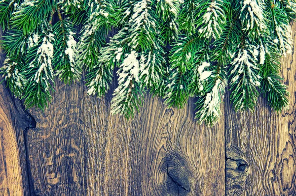 Christmas tree branches on rustic wooden background. Vintage sty — Stock Fotó