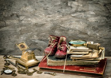 Antique books and photos, writing accessories and old baby shoes
