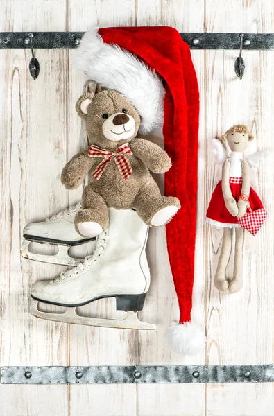 Red Santas hat, Teddy Bear, angel, ice skates. Christmas decorat — Zdjęcie stockowe