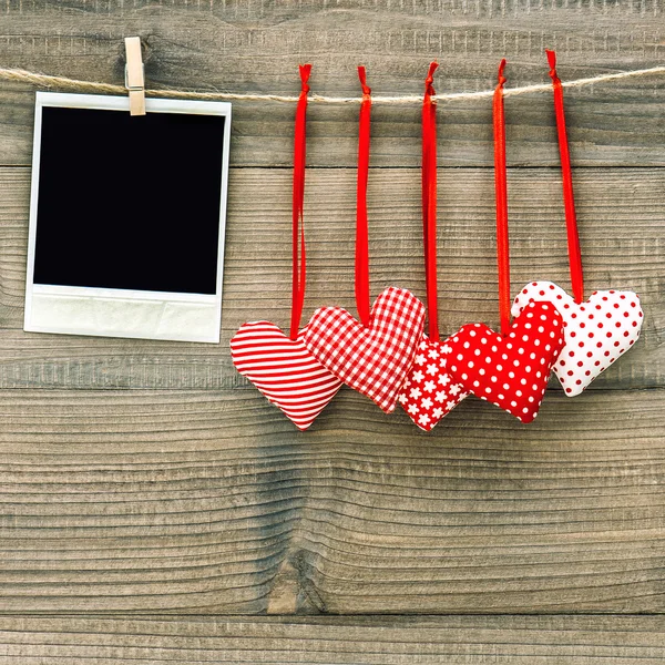 Polaroid photo frame and textile red hearts. Valentines Day — Φωτογραφία Αρχείου